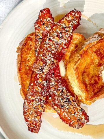 Strips of everything seasoning candied bacon with french toast.