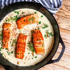 Cast iron skillet with Seared Salmon in Lemon Dill Cream Sauce