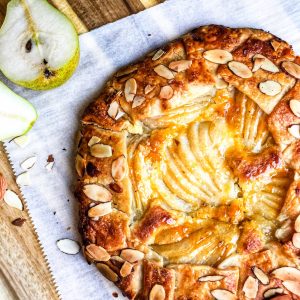 Pear and Frangipane Galette on a cutting board with sliced pear halves.