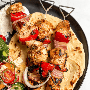 Greek Chicken Skewers with Tzatziki Sauce, Greek Salad, and Garlic Butter Naan