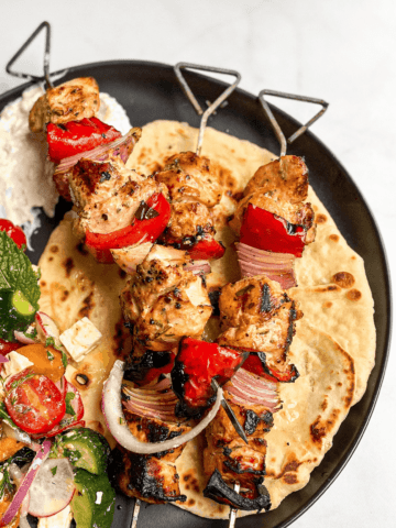 Greek Chicken Skewers with Tzatziki Sauce, Greek Salad, and Garlic Butter Naan