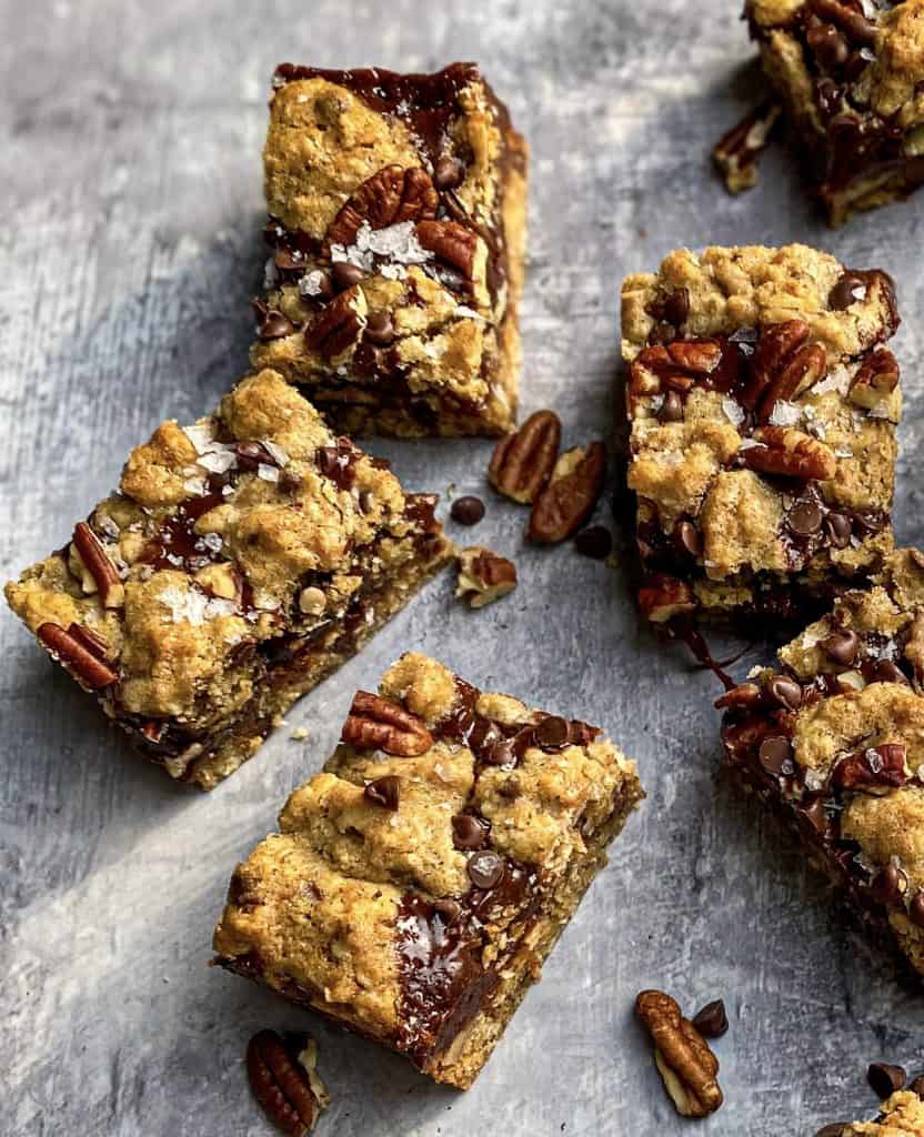 These Dark Chocolate Caramel Oatmeal Rye Bars feature a rich dark chocolate caramel with buttery oatmeal rye layers and a sprinkle of chocolate chips and pecans.