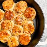 Cast iron pan of ham and Swiss buttermilk biscuits