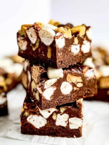 A stack of Rocky Road Chocolate Shortbread Bars with the addition of chopped Kit Kat Bars!