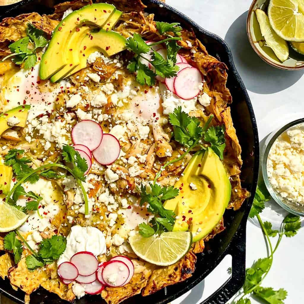 Chicken Chilaquiles Verde with Baked Eggs in a cast iron pan