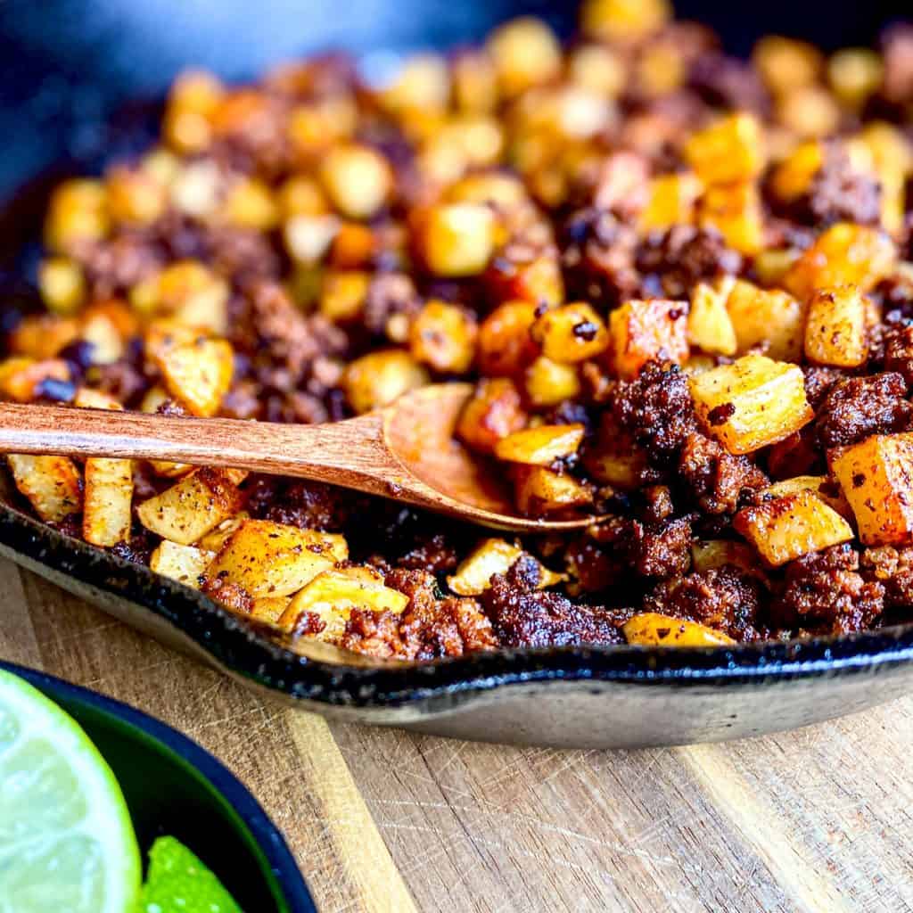 Cast iron pan filled with Homemade Chorizo with Potatoes.