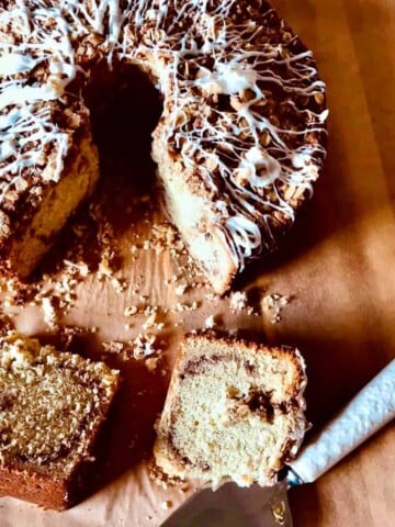 Two slices of Sour Cream Banana Coffee Cake on a cutting board.