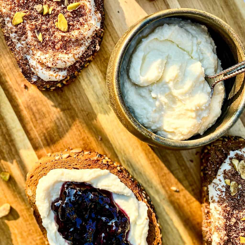 Fresh Homemade ricotta on two different toasts; shaved chocolate and pistachio, and fresh blueberry preserves.