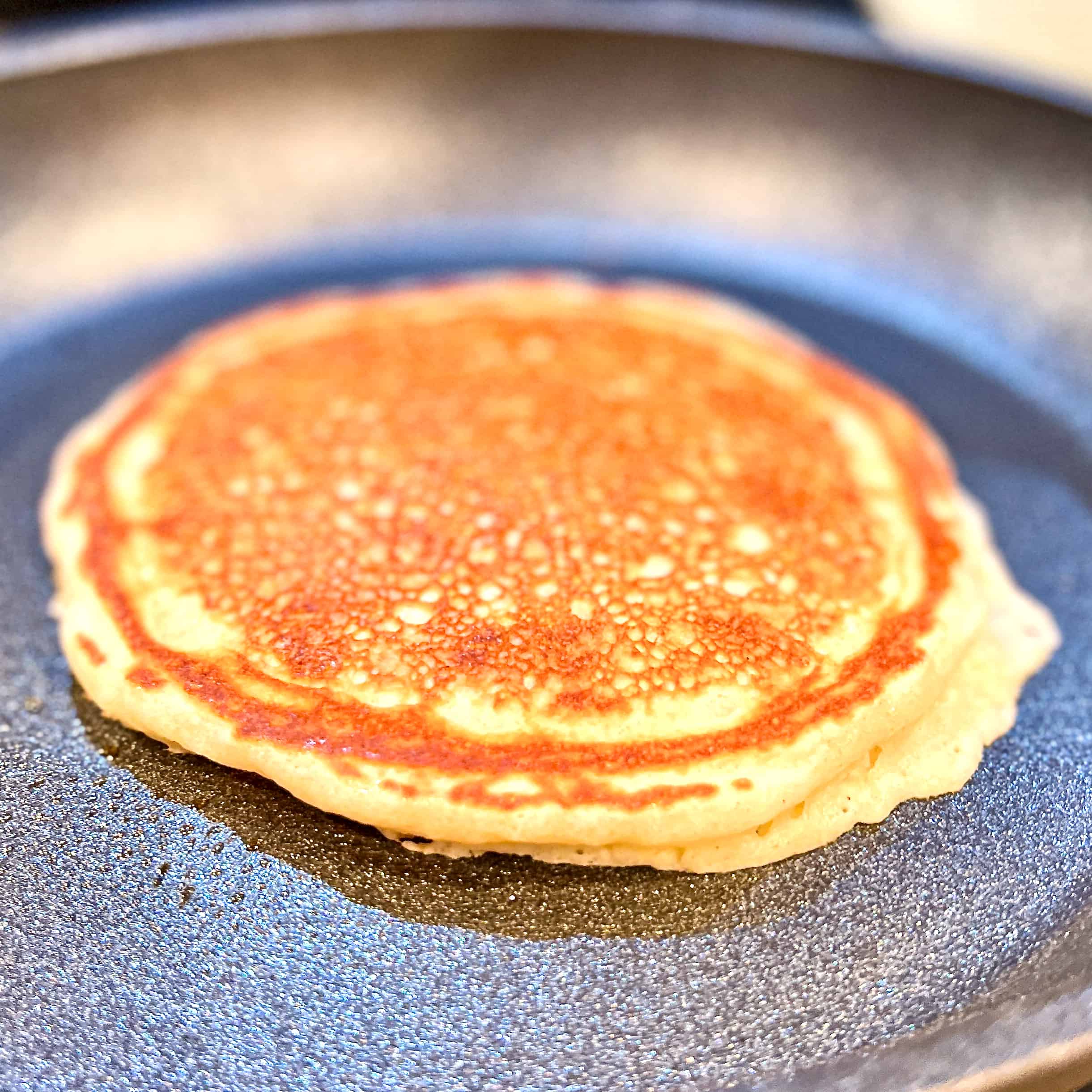 Finishing cooking a pancake in a cast iron pan.