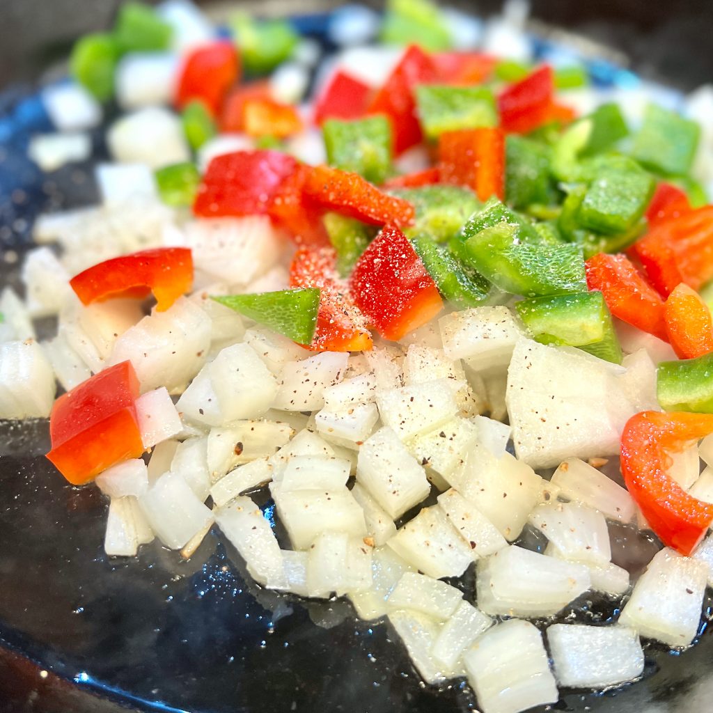 Sauteeing vegetables for hash.