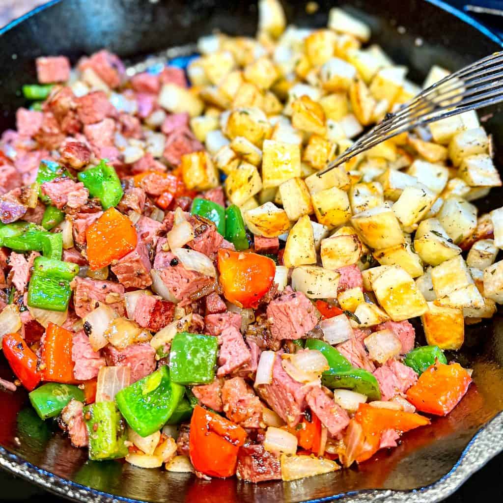 Making corned beef hash in a cast iron skillet.