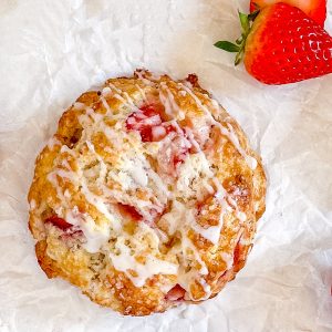 Strawberry and rosemary scone with fresh strawberries on the side.