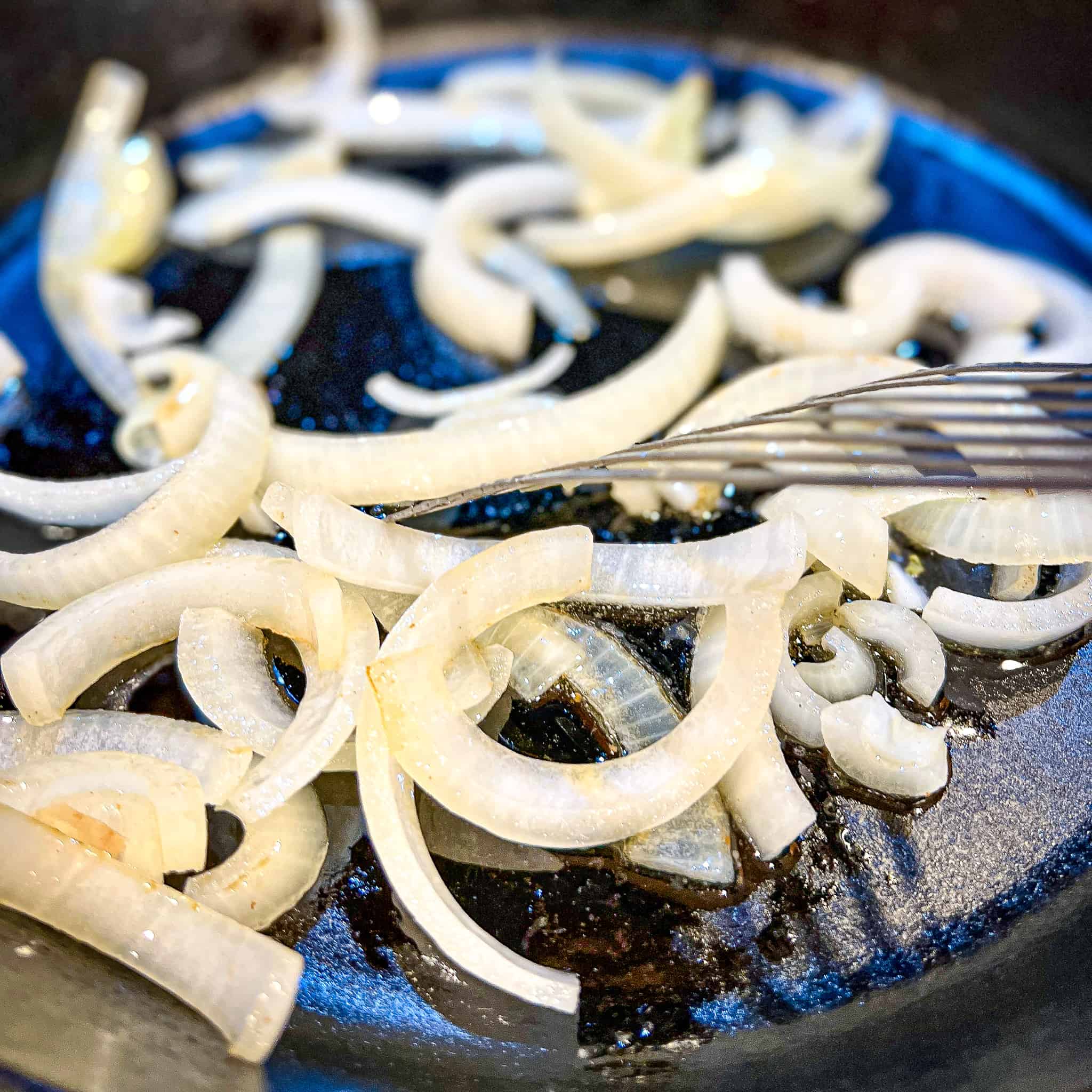 Sauteing onions in a cast iron pan.