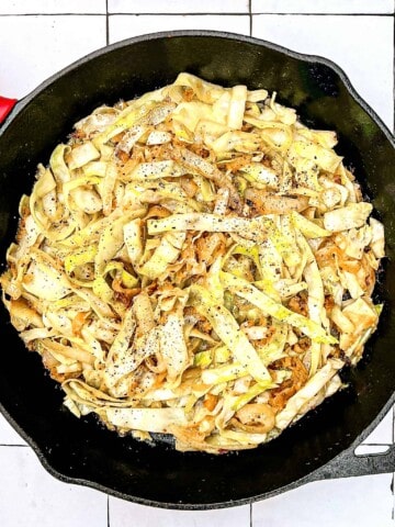 Sautéed Cabbage and Sauerkraut in a cast iron pan.