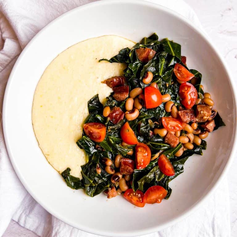 Cheesy Grits with Collard Greens & Black Eyed Peas in a white bowl.