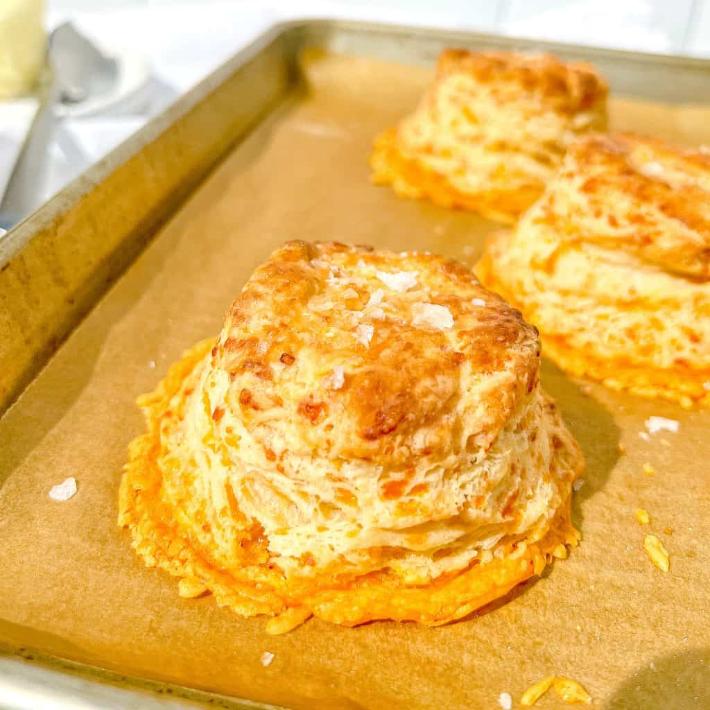 Crispy Cheddar Biscuits on a sheet tray.
