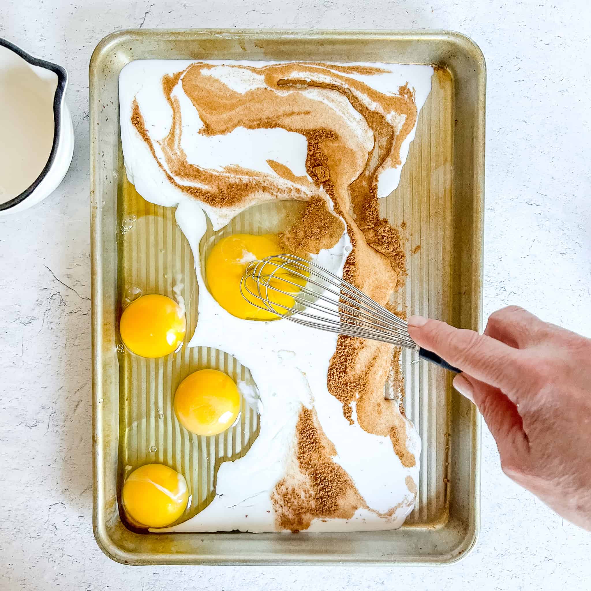 Whisking french toast custard.