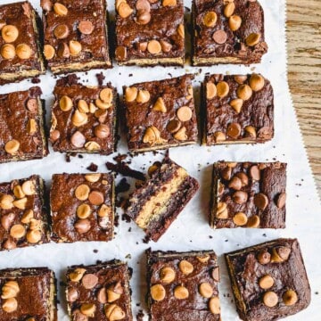 Peanut butter stuffed brownies on parchment paper.