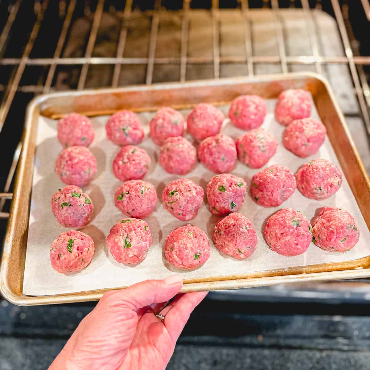 raw meatballs on a sheetpan.