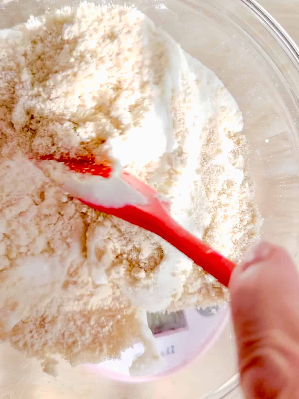 Mixing buttermilk into biscuit dough.