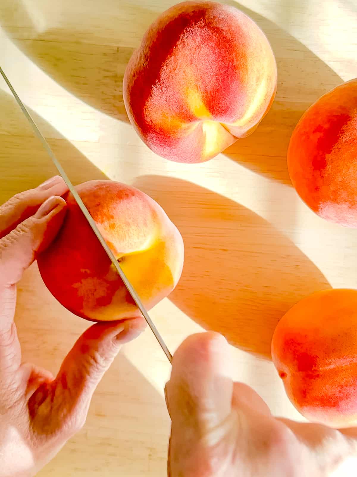 Slicing into a peach.