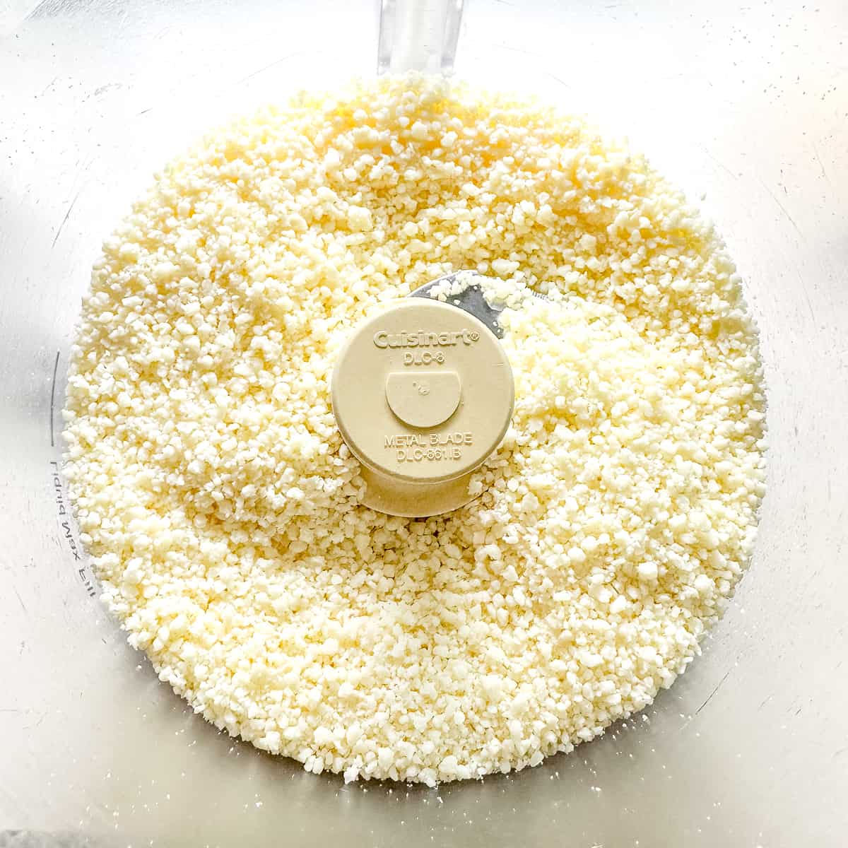 Ground romano cheese in a food processor.