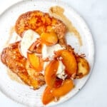 brown butter peach french toast with greek yogurt cream and toasted pecans.