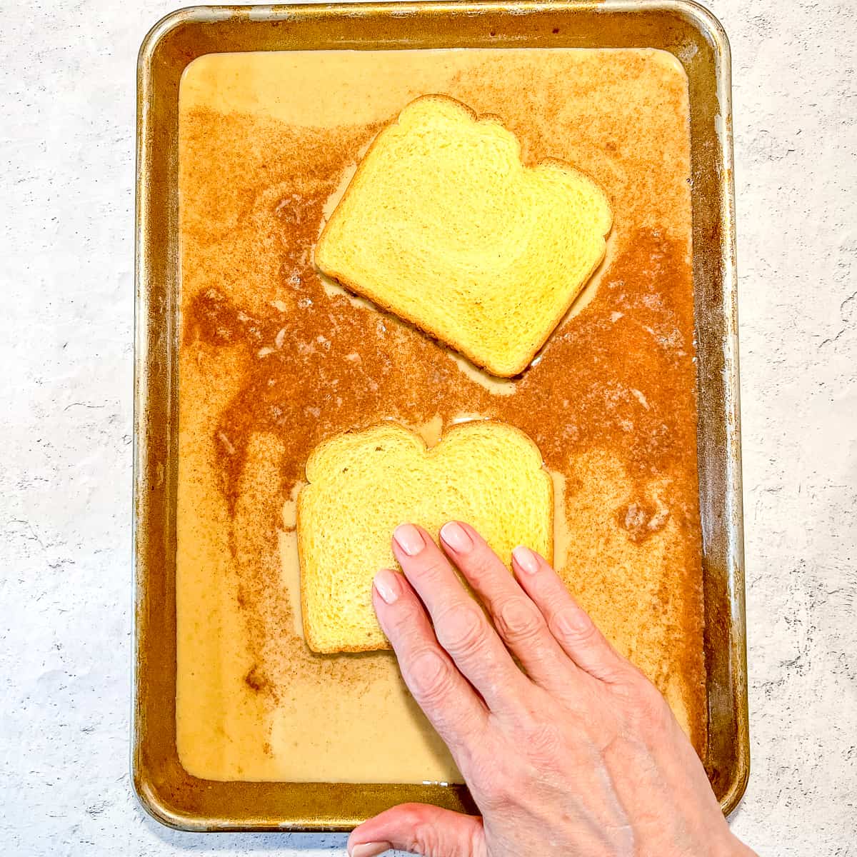 soaking bread in french toast custard.