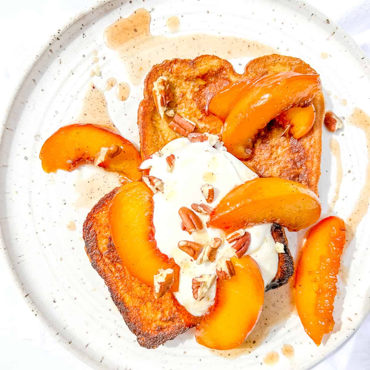 french toast with brown butter peaches, yogurt cream, and pecans.