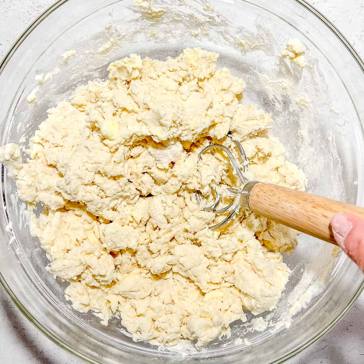 mixing biscuit dough in a bowl.