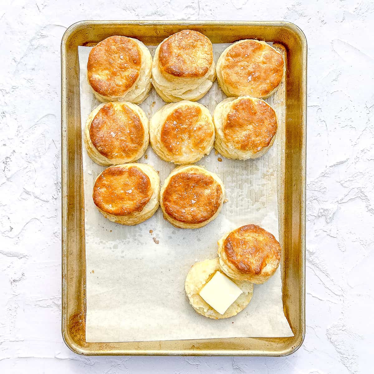 overhead shot of buttermilk biscuits on a sheet pan.