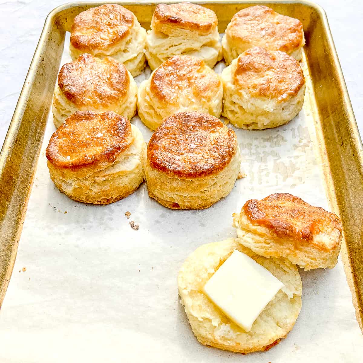 45 degree angle shot of buttermilk biscuits on a sheet pan.