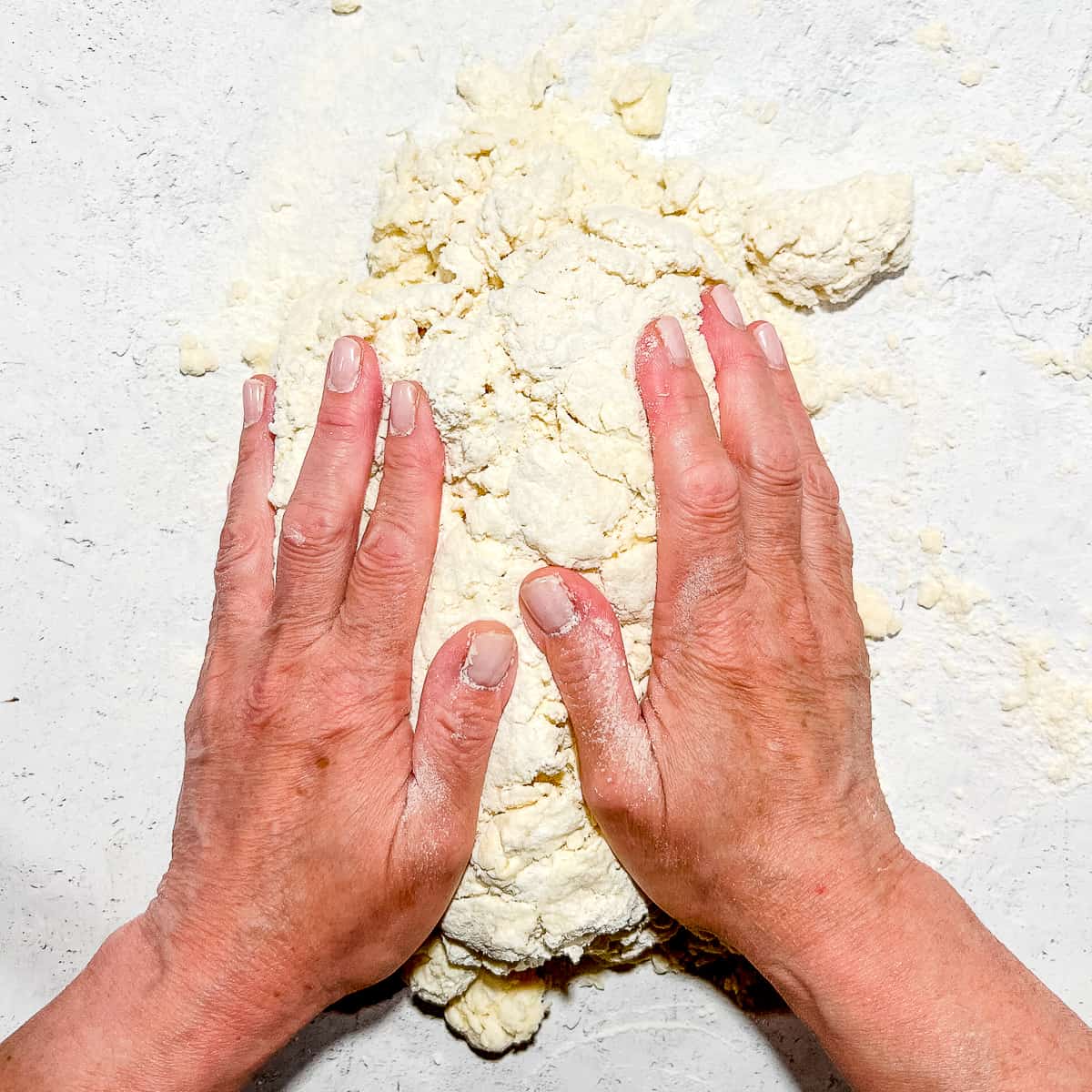 patting dough into cohesive mound.