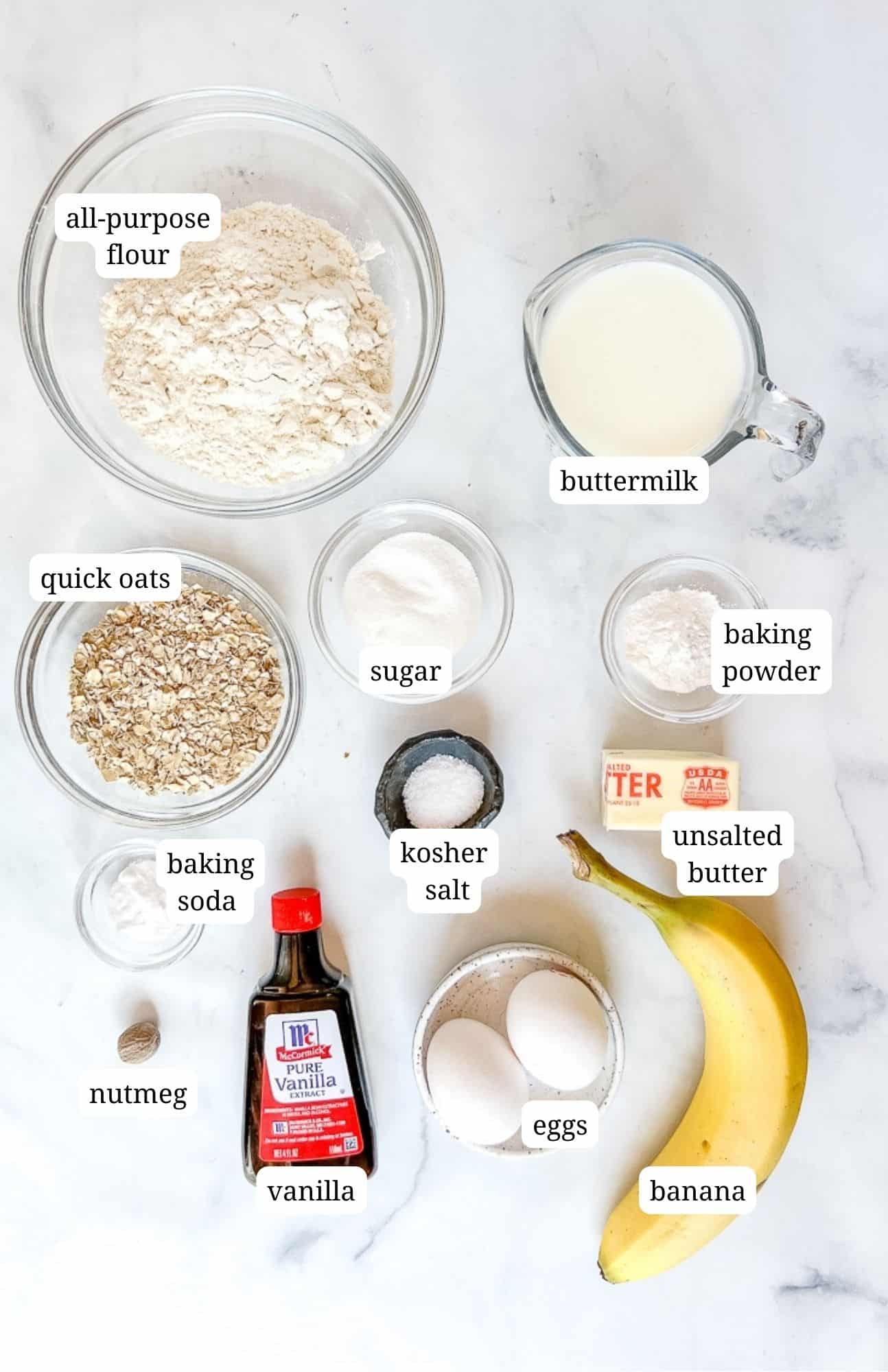 ingredients for banana oat pancakes on a marble counter.