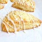 up close image of glazed orange buttermilk scones.