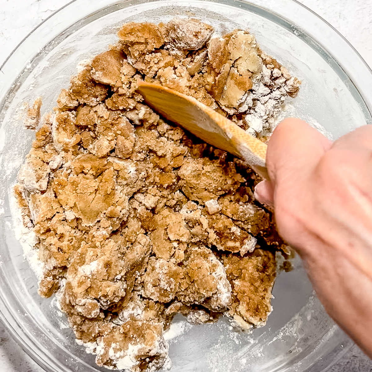 mixing crumb topping with a wooden spoon.