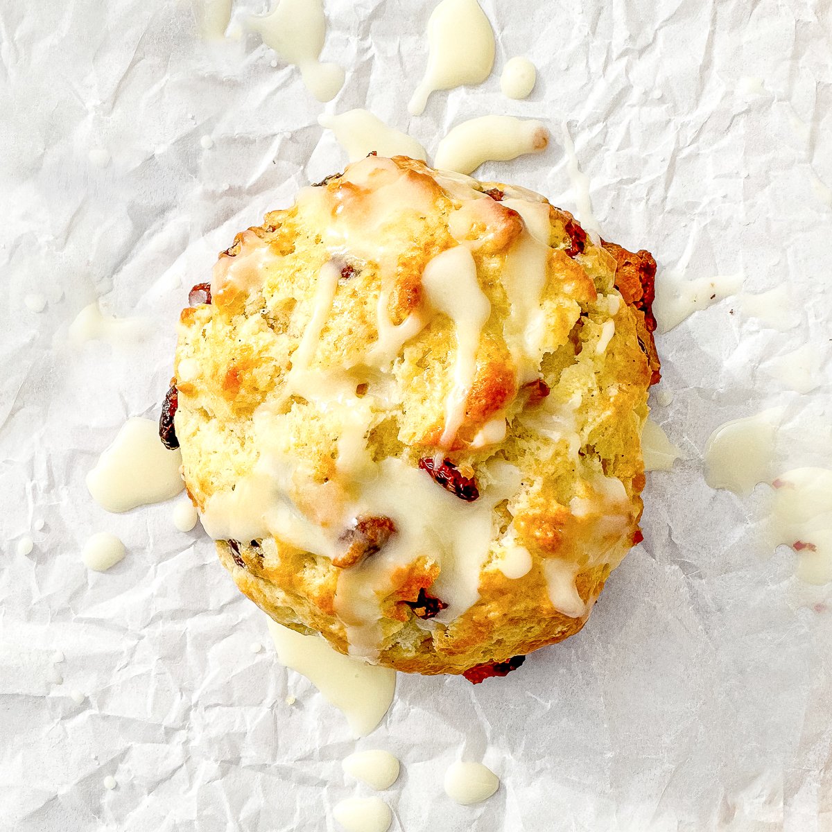 orange cranberry drop scone on parchment paper.