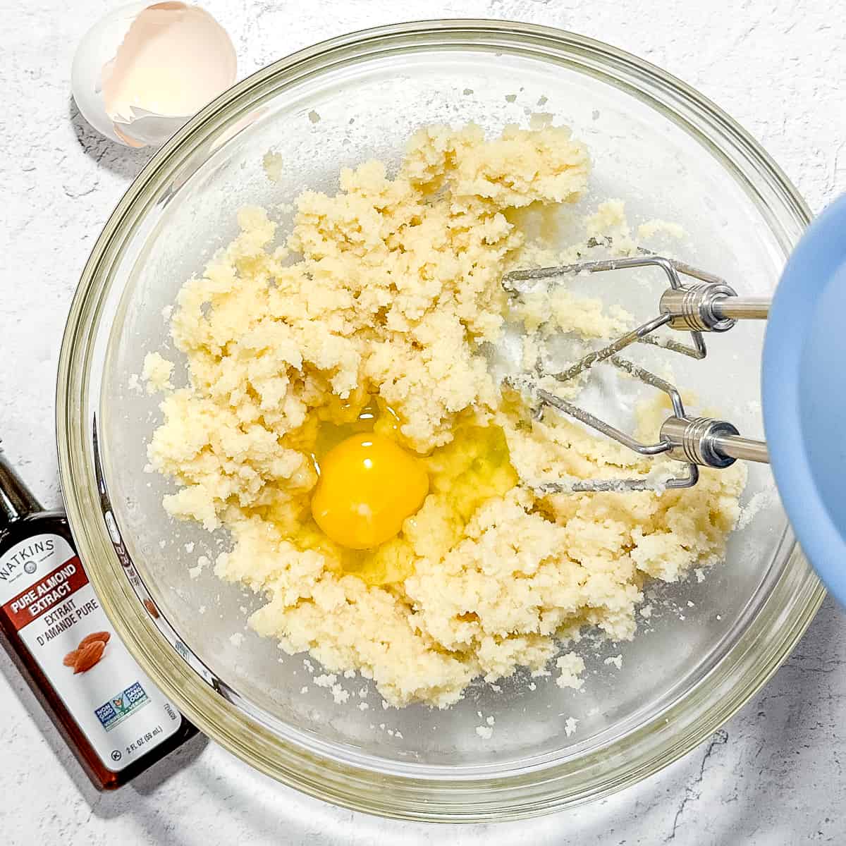 adding egg and almond extract to frangipane mix.