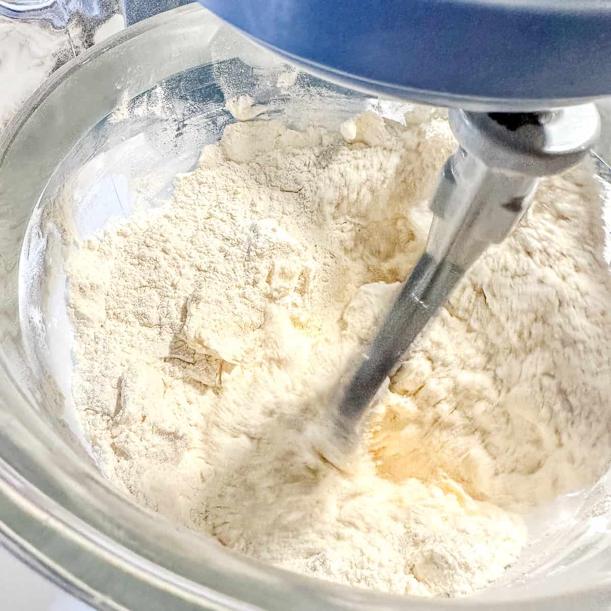 mixing shortening into dry ingredients for biscuit mix.