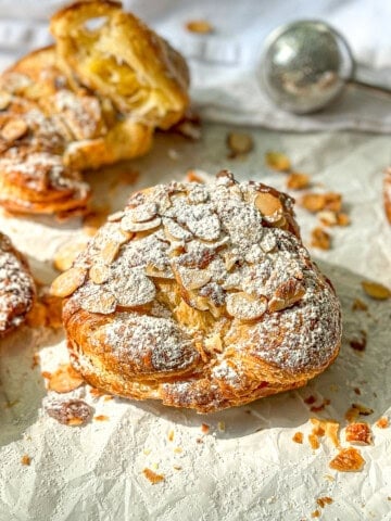 Almond croissants on parchment paper.