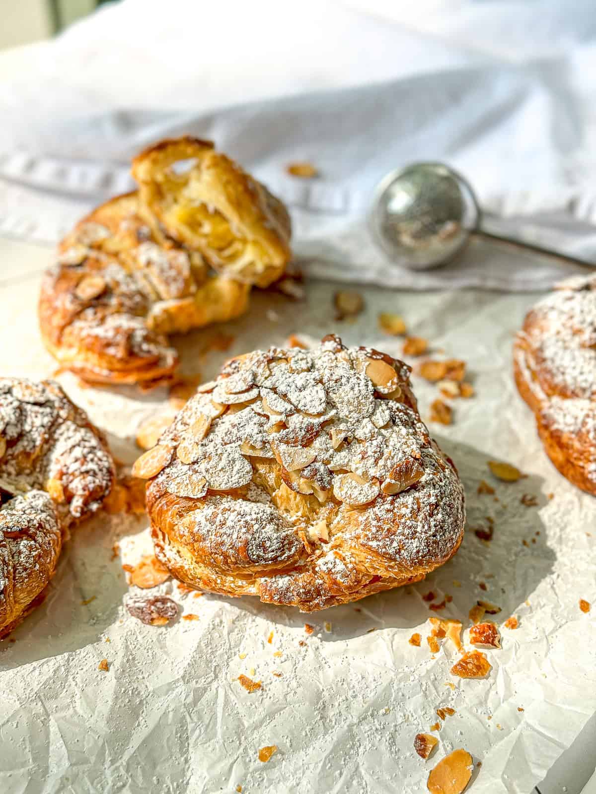 Almond croissants on parchment paper.