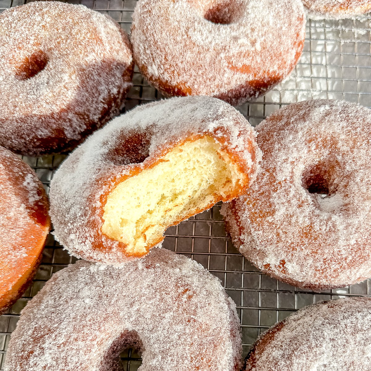 close up of a donut with a bite taken out.