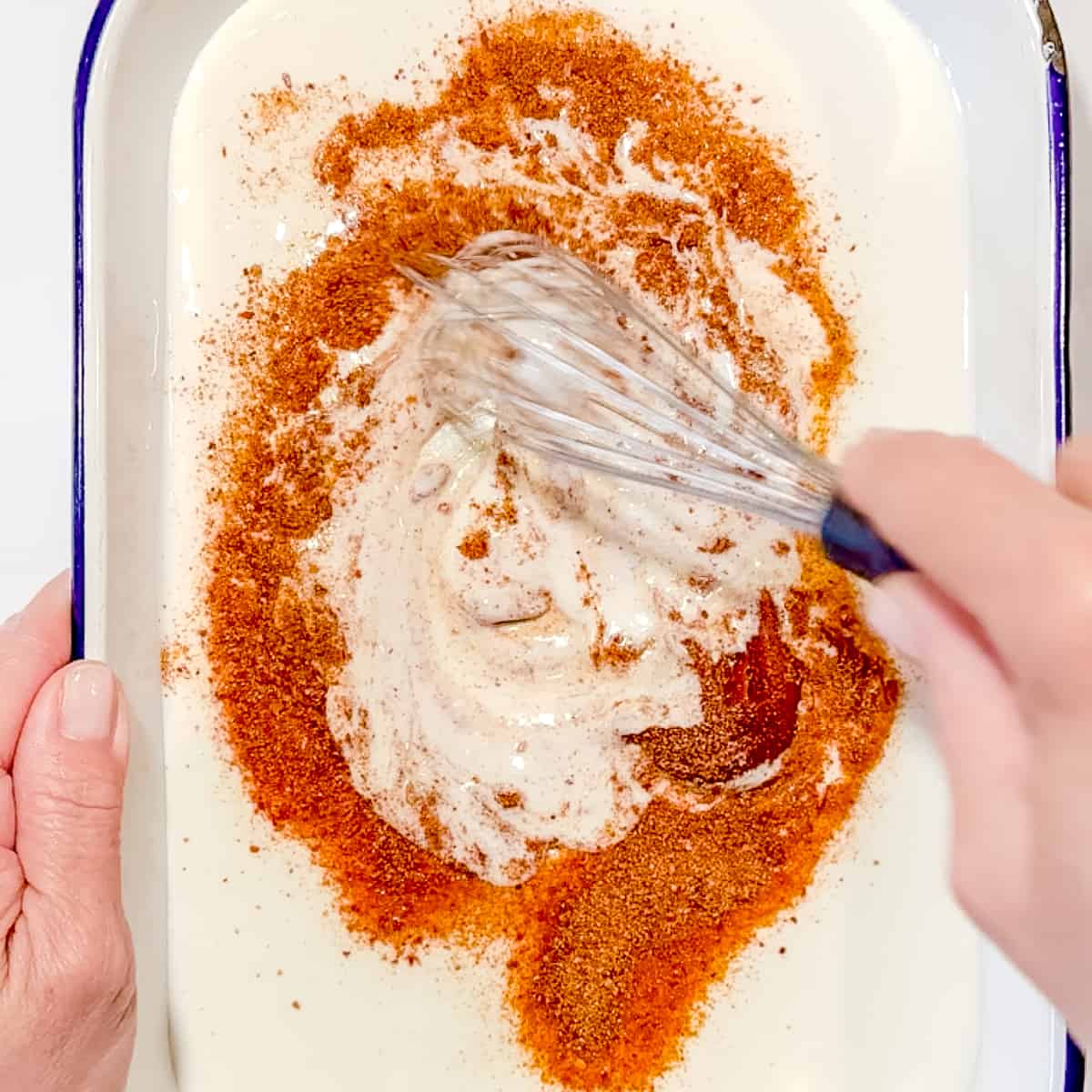 whisking the buttermilk brine for korean fried chicken.