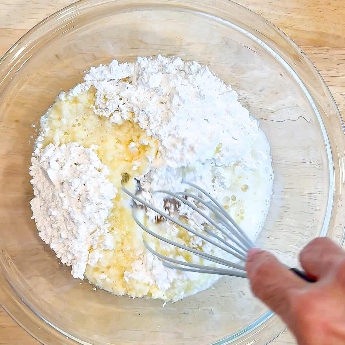 Whisking a glaze in a glass bowl.