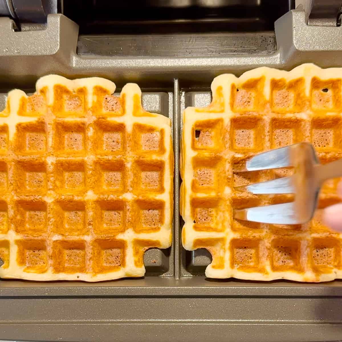 using a large fork to remove waffles from waffle maker.