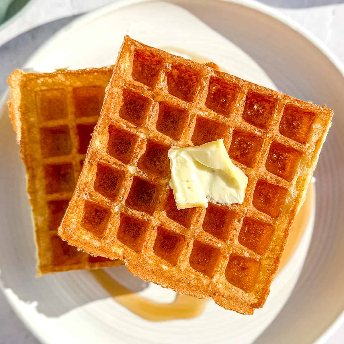 close up of yeast waffles with butter