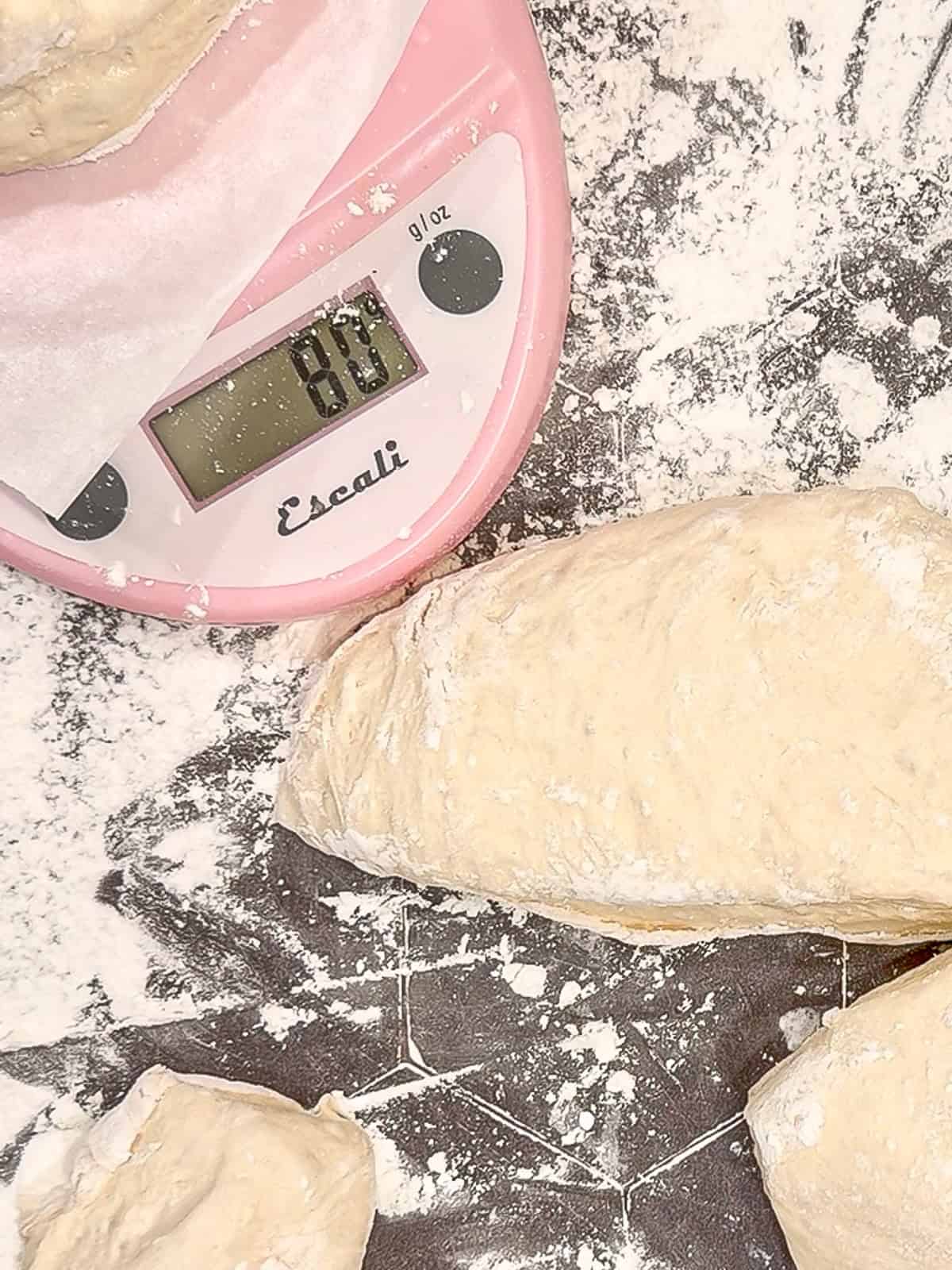 Using a scale to weigh the dough pieces.