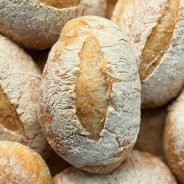 A pile of baked crusty rolls.