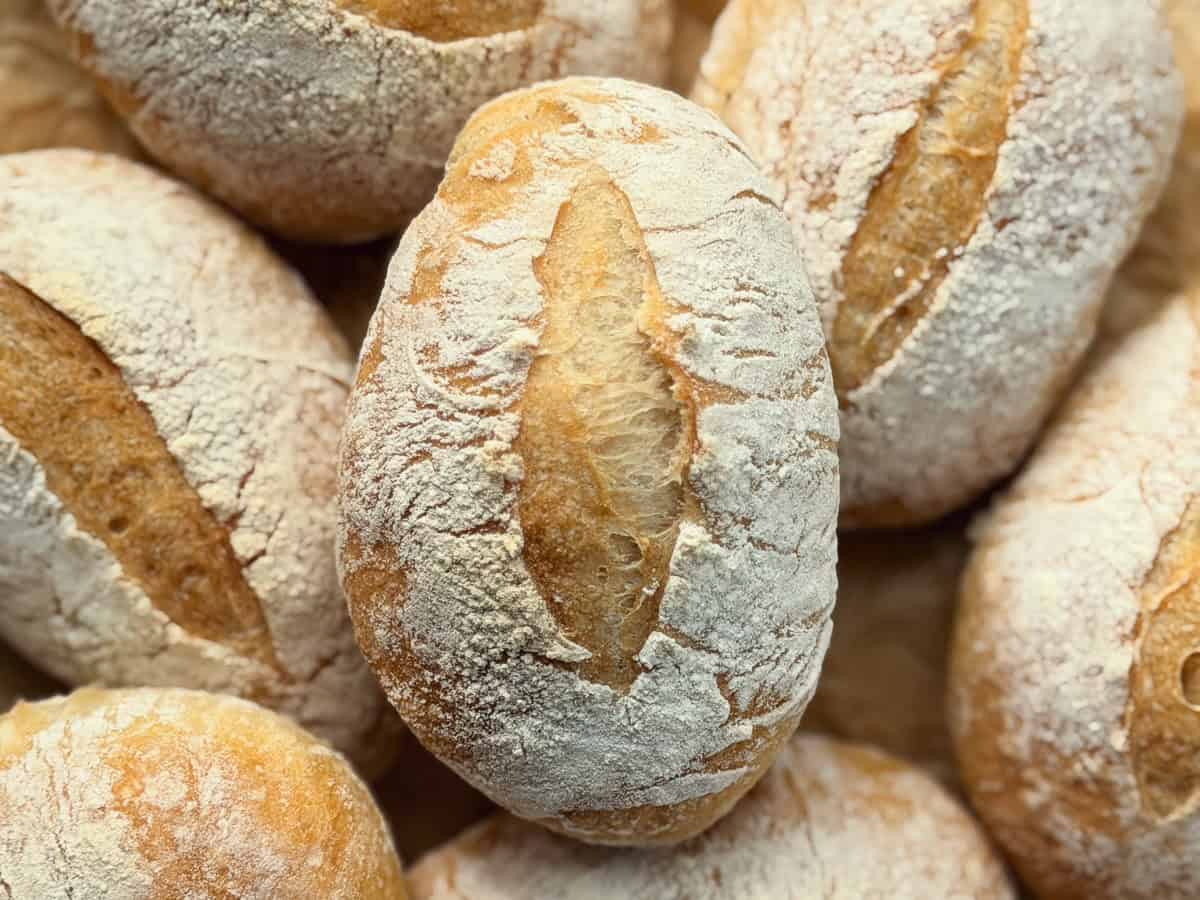 Homemade crusty bread rolls with crisp golden crusts.
