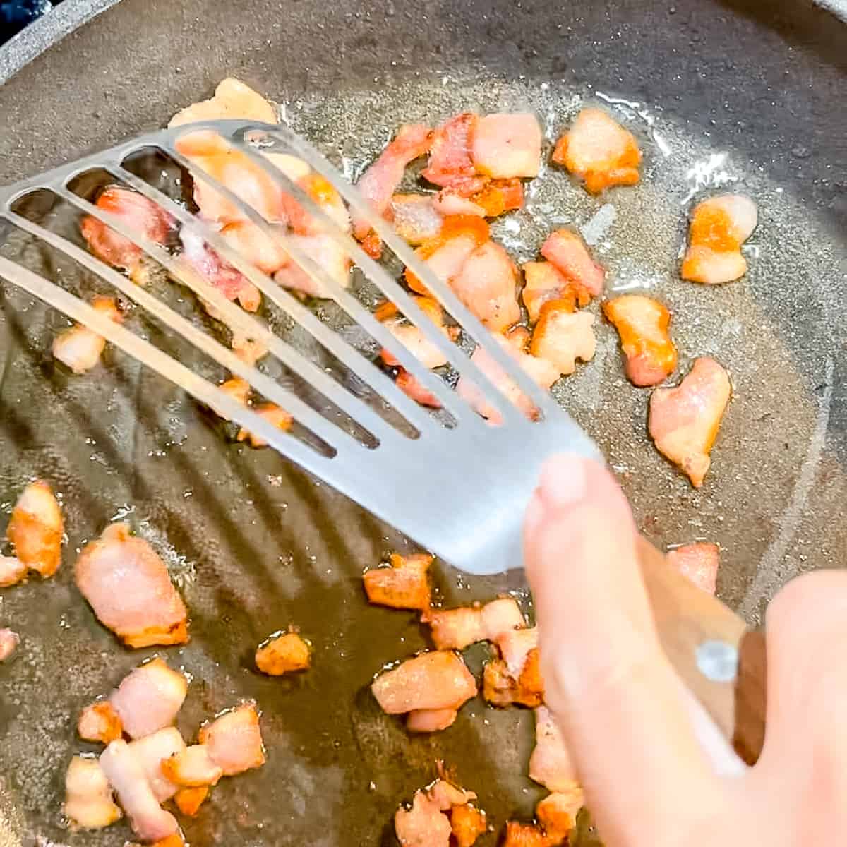 sauteing bacon in a nonstick pan.